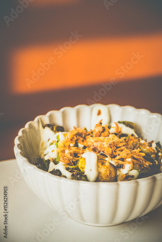 Burnt Brussels Sprouts with Char, Cream, and Umami Honey miso glaze, sour cream, fried shallots, chives
