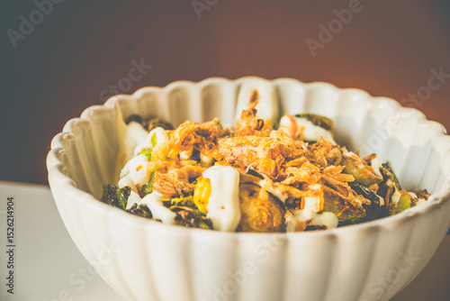 Burnt Brussels Sprouts with Char, Cream, and Umami Honey miso glaze, sour cream, fried shallots, chives