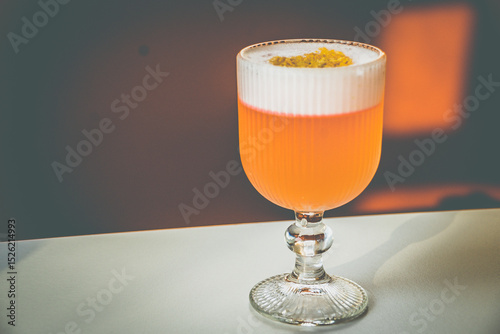 A Coconut Campari cocktail made with.Campari, gin, coconut, lemon