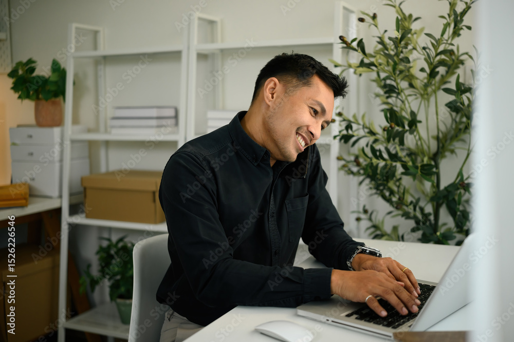 © saltdium - A Mature Businessman Multitasking on Phone and Laptop, Modern Professional Communication