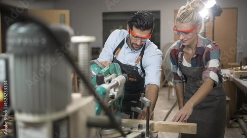 Carpenters are working together at workshop. Small business and craft product.