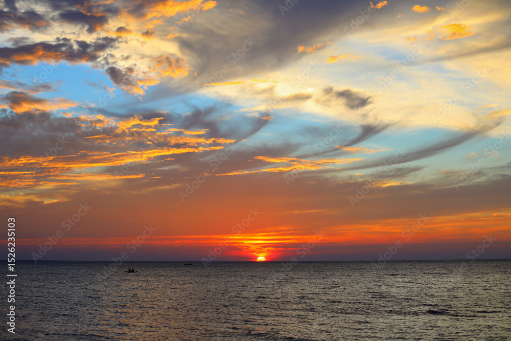 Fototapeta premium Colourful sunset over sea with it's reflection as background