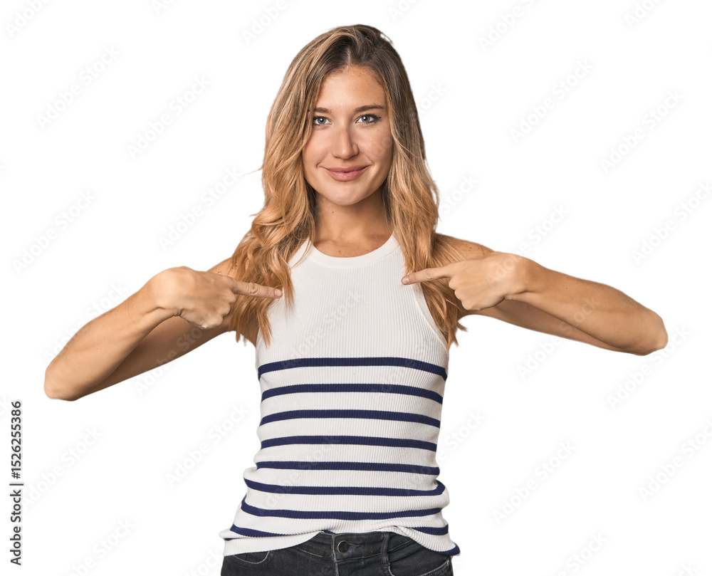 Fototapeta premium Caucasian blonde woman in studio surprised pointing with finger, smiling broadly.