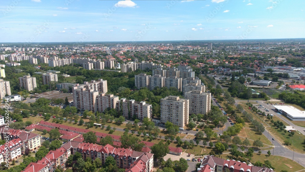 Fototapeta premium Densely populated urban area, apartment blocks, panel flats, residential buildings, well planned green spaces. Structured city layout, road network, and modern infrastructure. Housing estates. 