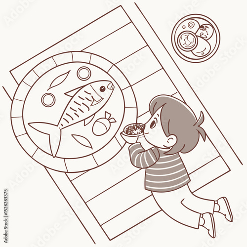 Child's Delight: Overhead View of a Youngster Enjoying a Meal with Fish