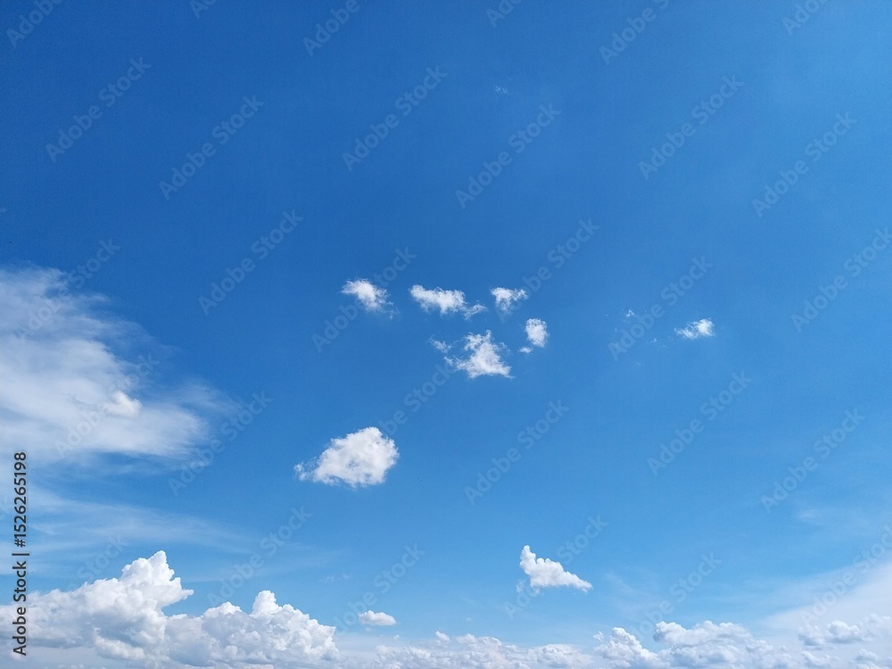 Fotografie Vast sky with floating cotton clouds