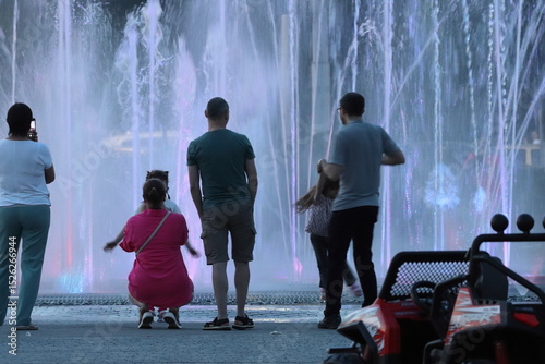 People admire the illuminated musical fountain