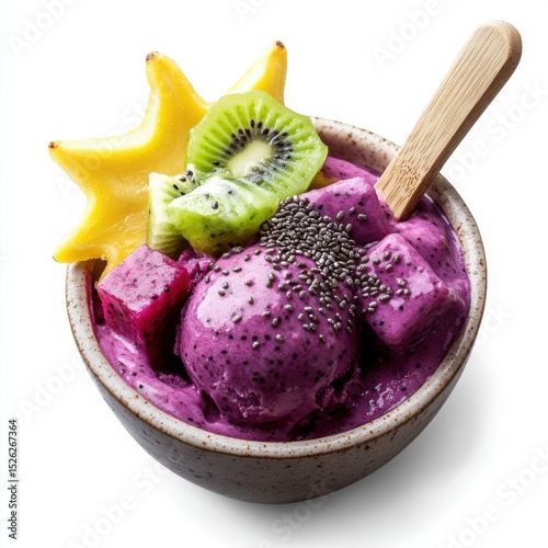 ice cream in a small ceramic bowl, artistically topped with dragon fruit cubes, starfruit slices, and kiwi photo