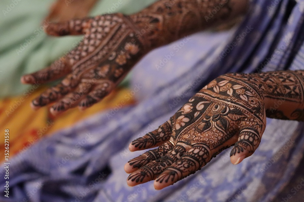 Fototapeta premium A close-up view of a girl's hands adorned with intricate mehndi (henna) designs, a traditional Indian body art often applied during weddings, festivals, and celebrations.