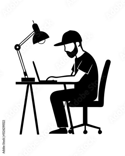 Person working diligently at a desk under a lamp in a minimalist workspace during the evening hours