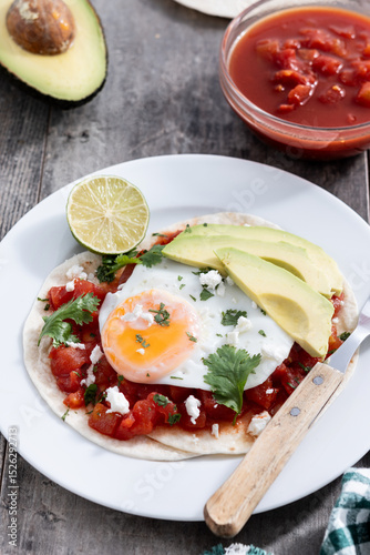 Huevos Rancheros. Traditional Mexican breakfast on wooden table