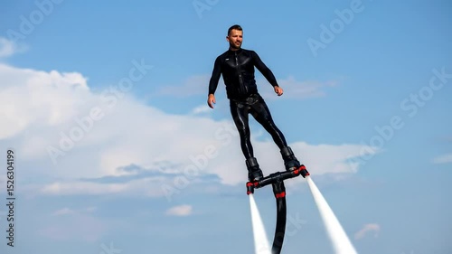 Man Flyboarding Over the Ocean: An Extreme Water Sport Adventure on a Sunny Day