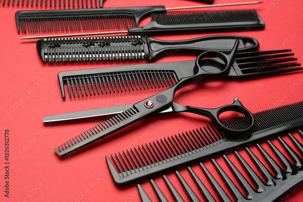 Different hairdresser's tools on red background, closeup Different hairdresser's tools on red background, closeup