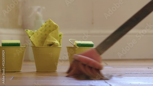 Spring cleaning sweeping room with a broom