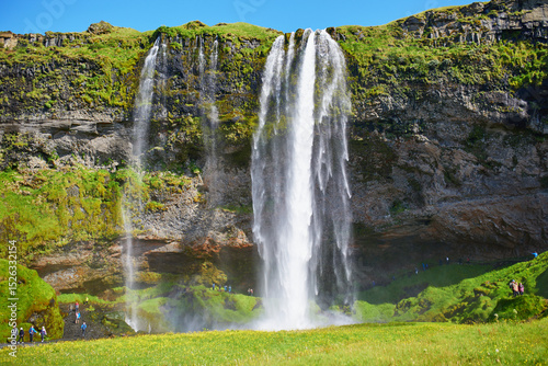 Scenic view of Seljalandsfoss, one of the biggest waterfalls of Iceland, with rainbow.