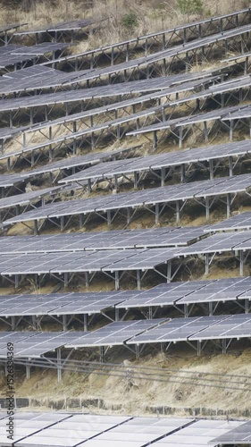 Renewable energy generation takes form as solar panels are installed on terraces in a rural location, showcasing eco-friendly technology in agriculture. Vertical video. Japan