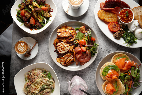 Overhead shot of different food dishes on a flat surface.