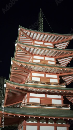 Chureito Pagoda illuminated at night, showcasing its unique architectural features against a dark sky. Vertical video