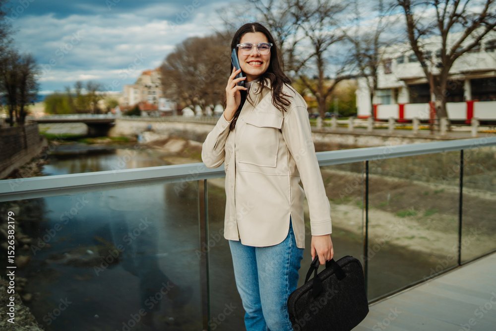 Fototapeta premium Young caucasian woman walk home from work drink coffee and use smartphone 