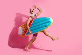 Photo of positive optimistic grandfather wear swimsuit summer vacation resort surfing isolated on pink color background