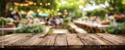 Rustic Wooden Table Overlooking an Outdoor Garden Setup with Blurred Background of Event Decor and Soft Ambient Lighting