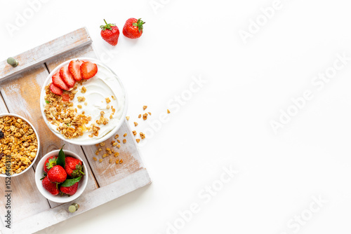 Flat lay composition with yogurt and muesli in bowl served with ingredients. Top view