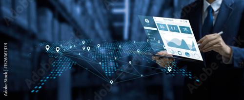 Businessman using digital tablet with real-time data analytics and GPS map network interface, illustrating smart logistics, supply chain management, and global tracking technology in a warehouse. photo