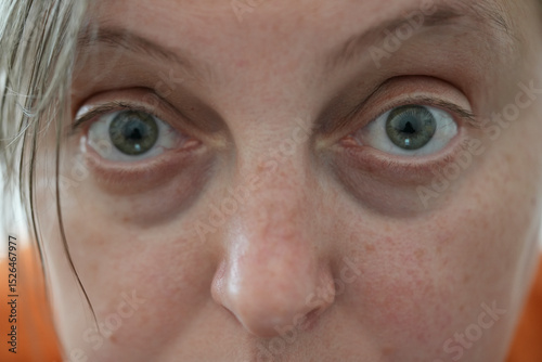 close-up of young woman's eyes looking straight into the camera, feminism, women's rights struggle