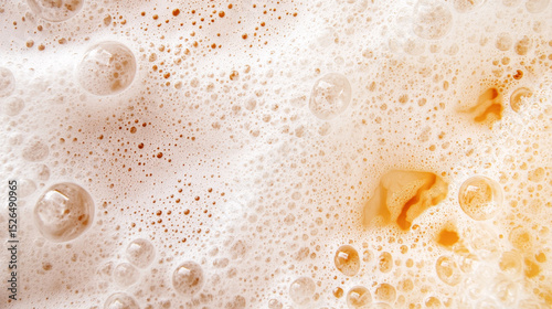 Rich, foamy beer head with varying bubble sizes and warm tones.