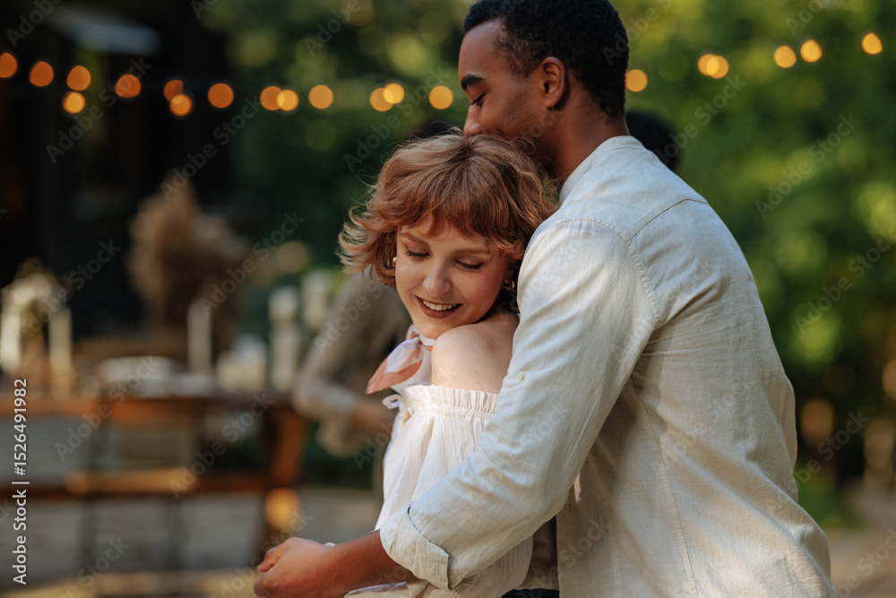 Fototapeta premium Cute redhead dancing in the loving embrace of her boyfriend