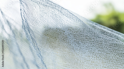 Close-up view of intricate light blue mesh fabric. Creates a soft, abstract background texture.
