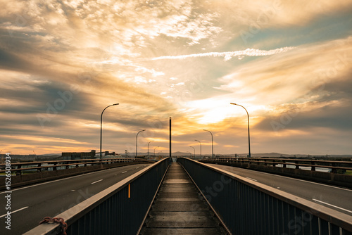 Walkway across top of Stockton Bridge between dual traffic lanes photo