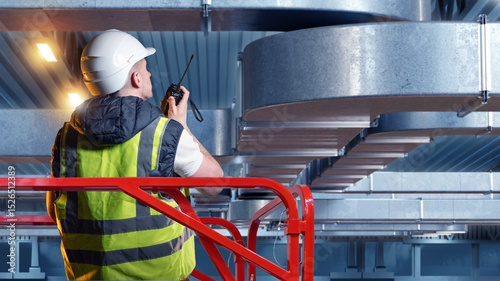 Technician in safety vest a...