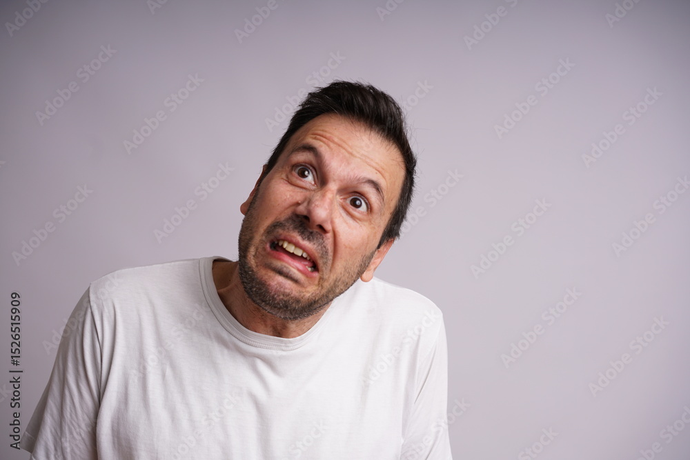 Fototapeta premium Male Model Showing Different Emotions on White Studio Background