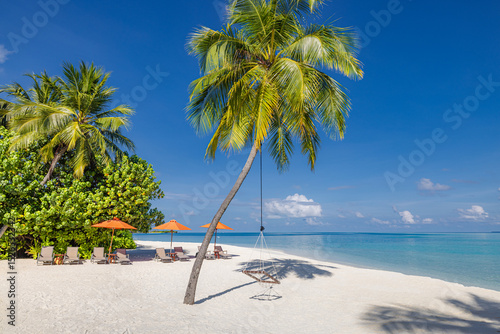 Fototapeta Naklejka Na Ścianę i Meble -  Inspire tropical beach resort pool palm trees chairs umbrellas leisure tourism sunny blue sky. Stunning sea view beach landscape. Summer vacation amazing coastal relaxation. Closeup sunshine sand wave