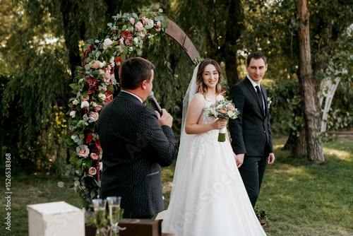 wedding ceremony of the newlyweds on the glade