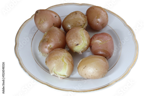 Boiled unpeeled potatoes on a porcelain plate.