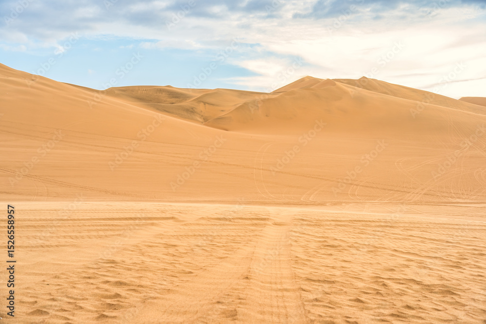 Golden sand dunes of Ica desert under a clear blue sky in Huacachina, Peru Golden sand dunes of Ica desert under a clear blue sky in Huacachina, Peru