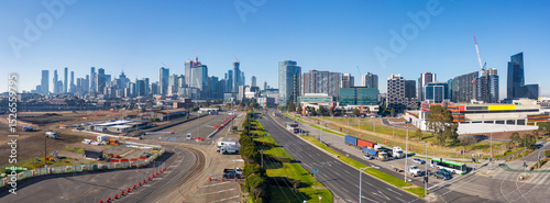 Aerial panorama of traffic on freeways leading into highrise city skyline Docklands, Melbourne, Vict