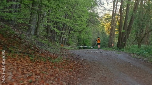 Male Runner Running Down Forest Road Hiking