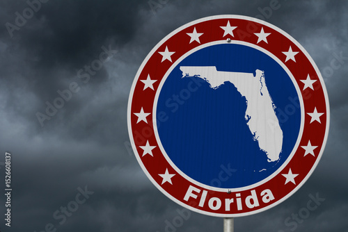 Florida map with stars on a US red, white and blue road sign with stormy sky