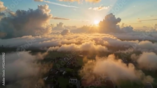 Aerial View of a Village Emerging from the Clouds at Sunrise