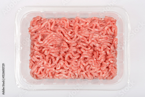 Tableau sur toile Overhead shot displays a clear plastic tray filled with raw, light pink ground m