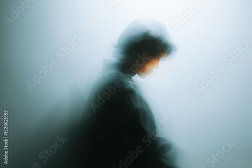 a blurry image of a person in a black jacket