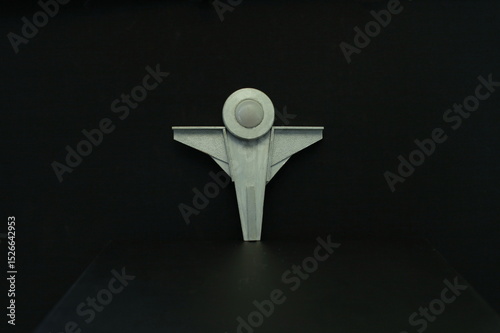 Angel in a silver space suit, dark space background, sculpture