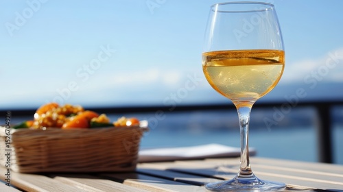 A refreshing beverage in a glass sits on a wooden table, accompanied by a basket of colorful fruit, This image conveys leisure and relaxation, ideal for marketing food, beverages
