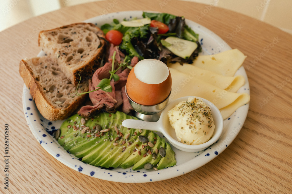 Sandwich with meat, avocado, egg and with freshly greens. Crop delicious breakfast served on wooden table in sunny indoor cafe. Part of a series Sandwich with meat, avocado, egg and with freshly greens. Crop delicious breakfast served on wooden table in sunny indoor cafe. Part of a series