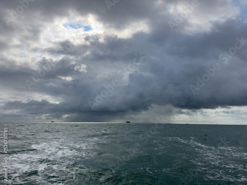 Storm clouds on the horizon whilst sailing a yacht in the Solent near the Isle of Wight photo