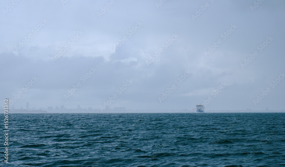 Fototapeta premium Stormy weather with squally clouds and rain in the Solent, on the South coast of the UK