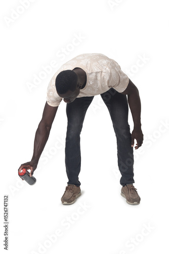 front view of a crouching man painting with a spray